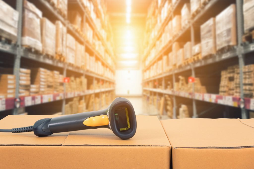 Barcode scanner in front of modern warehouse